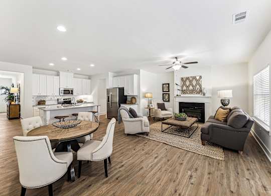 a living room with a table and chairs and a fireplace