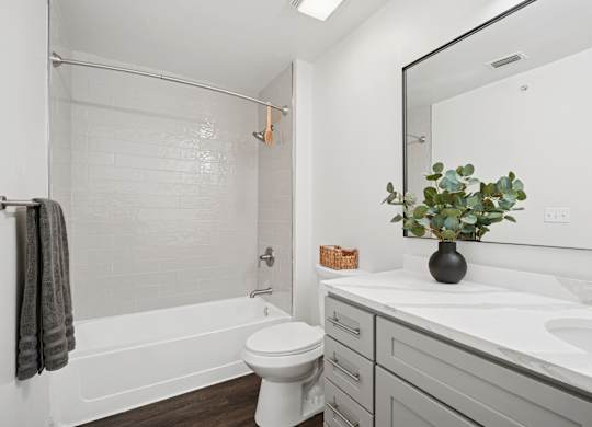 A bathroom with a white toilet, a white sink, and a white bathtub.