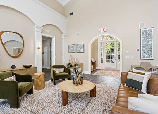 A living room with a green chair and a wooden coffee table.