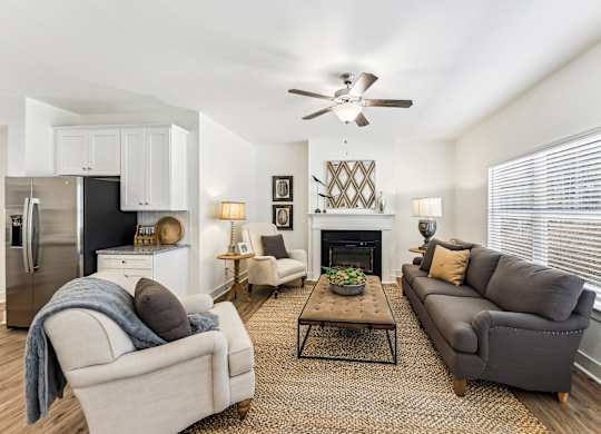 A living room with a grey couch, a coffee table, and a fireplace.
