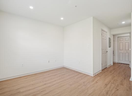 A room with white walls and wooden flooring.
