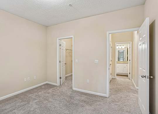 A room with a carpeted floor and white walls.