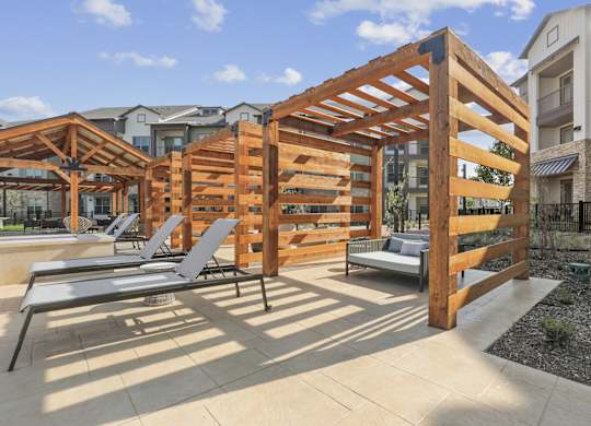 Poolside cabanas with lounge chairs and daybeds