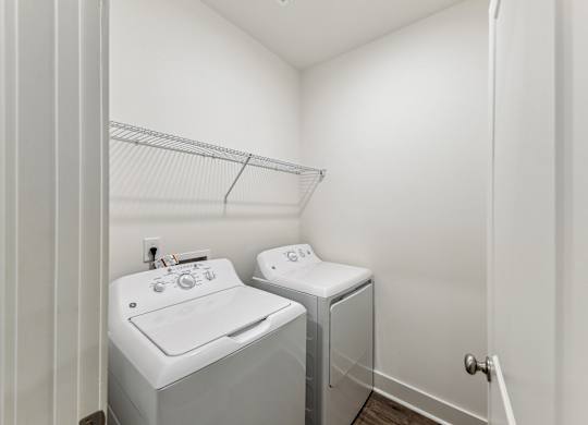 a washer and dryer in a laundry room with a sink and a closet