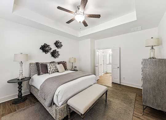 a bedroom with a bed and a ceiling fan