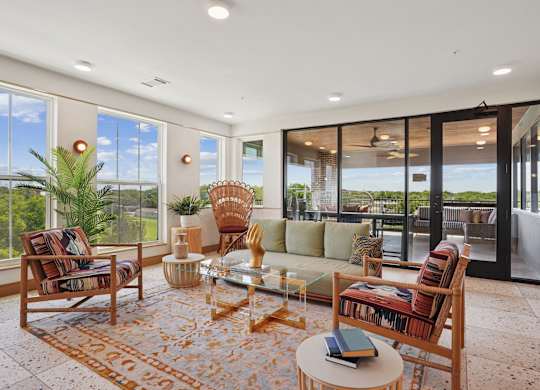 A living room with a sofa, chairs, and a coffee table.