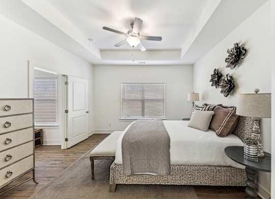 a bedroom with a bed and a ceiling fan