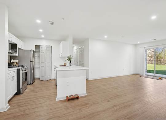 A kitchen with white appliances and cabinets is shown.