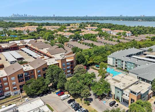 A bird's eye view of a residential area with a swimming pool and a bridge.