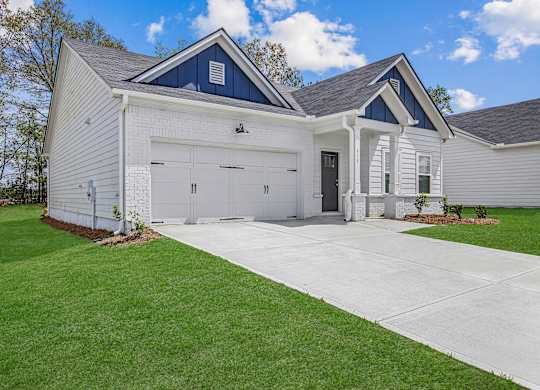 a white house with a driveway and a garage door
