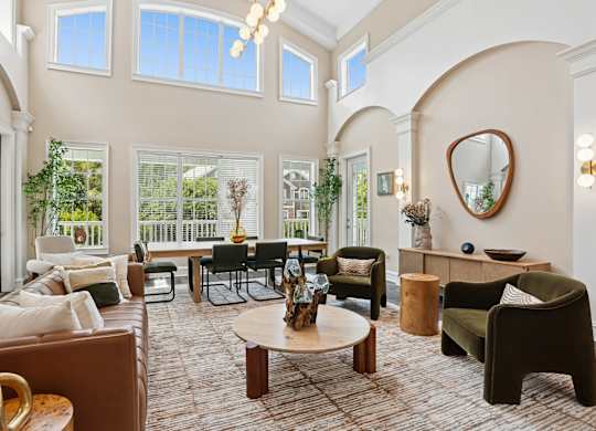 A living room with a brown couch and a round table.