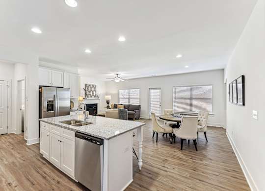 a kitchen and living room with a table and chairs