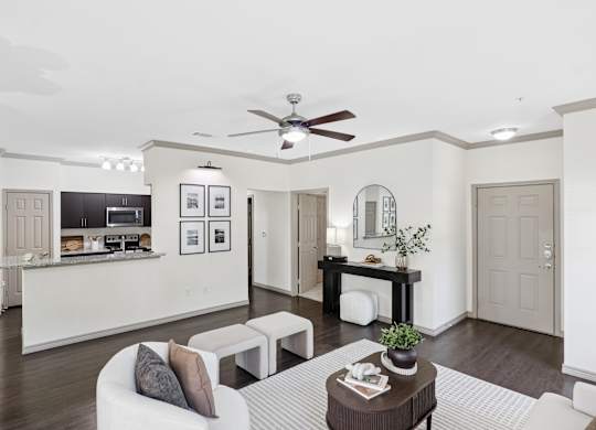 A modern living room with a white sofa and a coffee table.