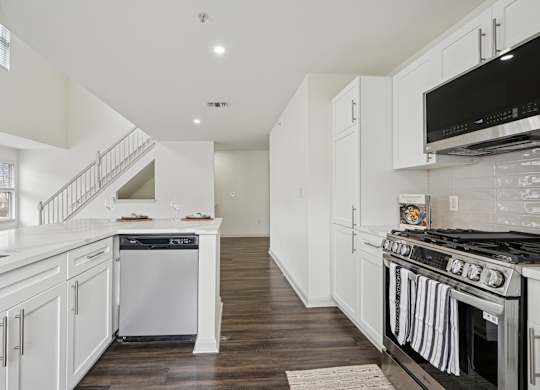 A white kitchen with a stove top oven.