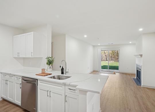 A kitchen with white cabinets and a dishwasher.