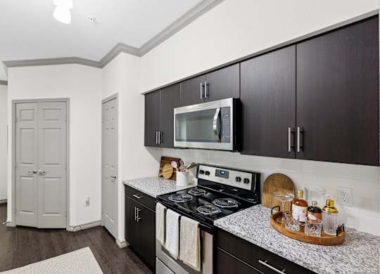 A kitchen with a stove top oven and a microwave.
