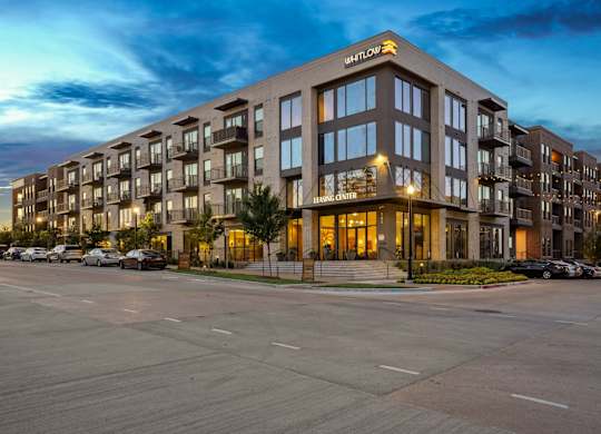 A large apartment complex called Whitlow is shown at dusk.