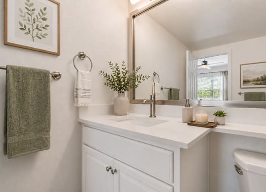 A bathroom with a white counter at St Moritz in Dallas Texas