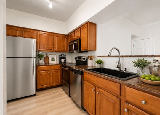A kitchen with wooden cabinets at St Moritz in Dallas Texas