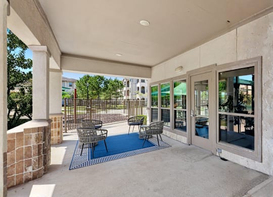 Covered patio with chairs next to the shaded Playground.