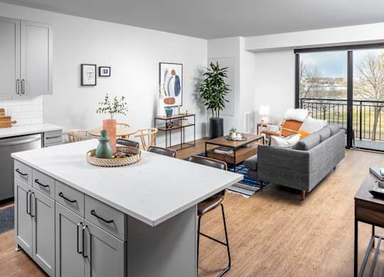 A modern kitchen with a dining table and chairs.