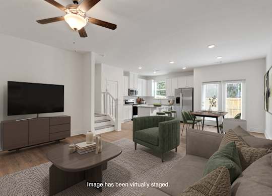 A living room with a brown couch and a television.
