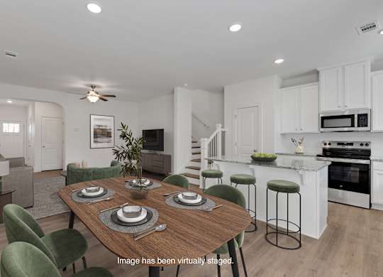 A modern kitchen with a dining table set for six.
