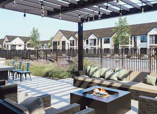 A patio with a fire pit and seating area.