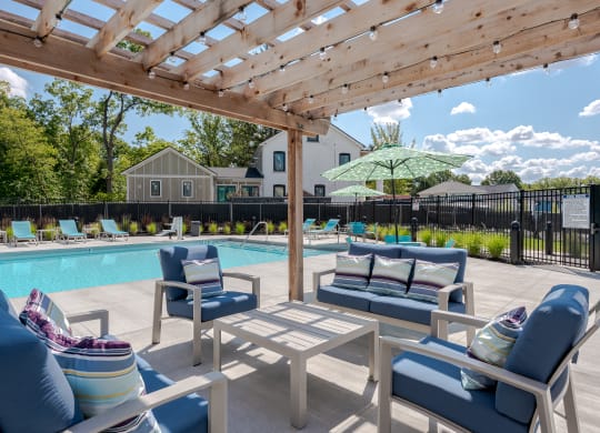 our apartments have a resort style pool with lounge chairs and a pergola