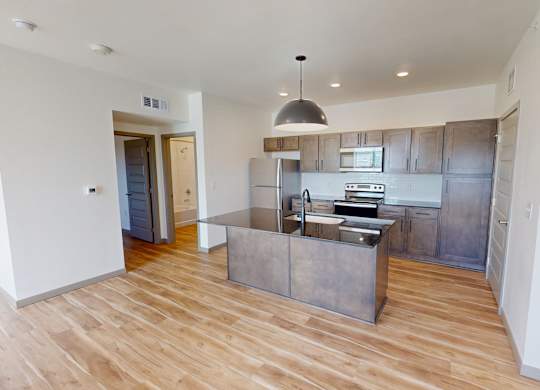 A kitchen with wooden floors and a modern design.