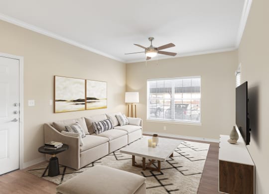 a living room with a couch and a ceiling fan