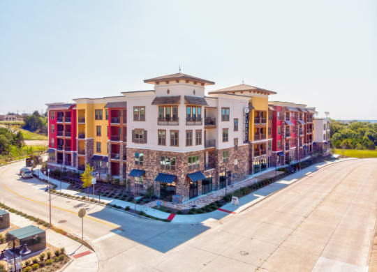 an aerial view of a large apartment complex with a parking lot in front of it