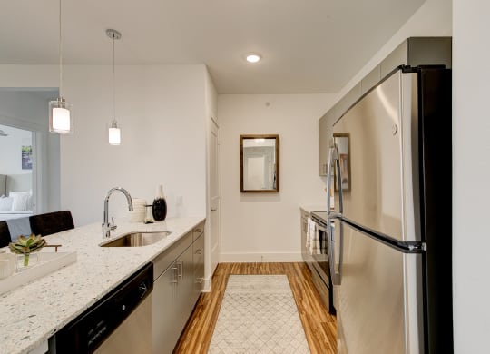 a kitchen with granite countertops and stainless steel appliances