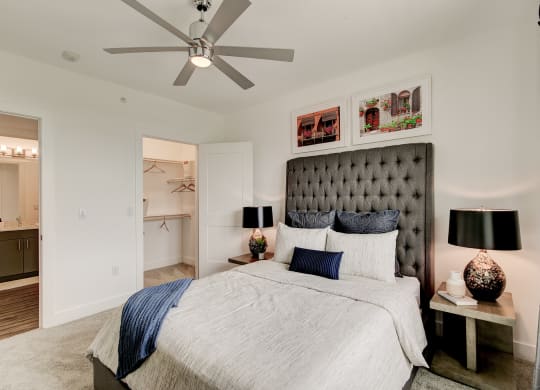 a bedroom with a bed and a ceiling fan