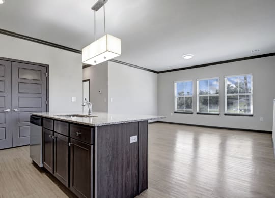 an empty kitchen and living room with a counter top