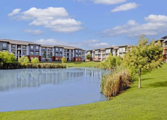 a pond in front of an apartment building