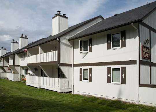 A white building with a sign that  says