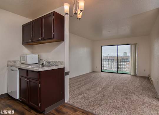 A kitchen area with brown cabinets and a white dishwasher.