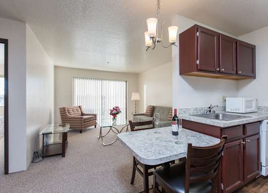 A kitchen with a table and chairs in the middle of the room.