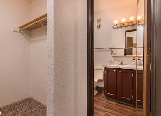 A bathroom with a towel rack and a mirror.
