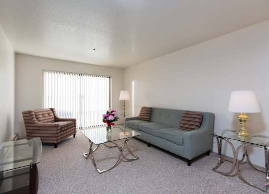 A living room with a couch, chair, and coffee table.