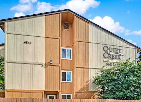 The Quiet Creek building has a brown and tan exterior.