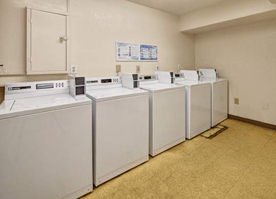 A row of washing machines in a laundromat.