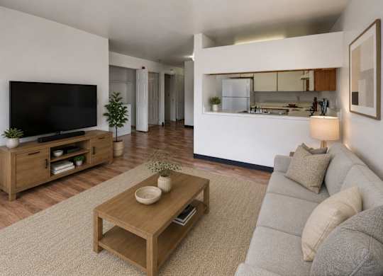 A modern living room with a grey sofa and a wooden coffee table.