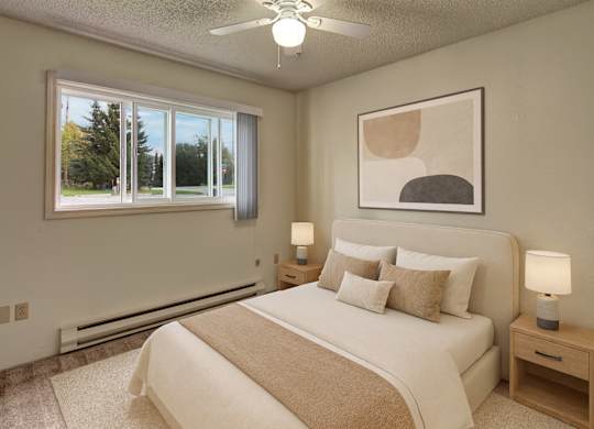 A cozy bedroom here at Terrace on the Lake with soft carpet, a comfortable bed with neutral bedding, matching nightstands with lamps, and a large window with vertical blinds that brings in natural light and outdoor views.