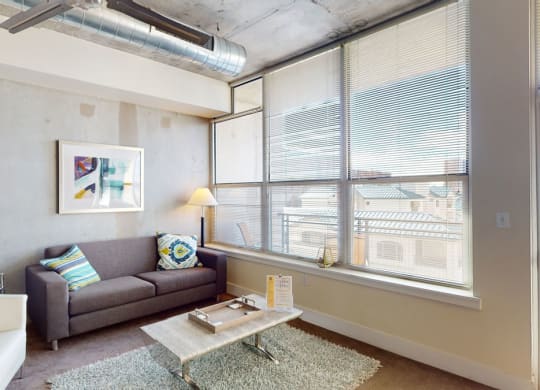a living area with a couch coffee table and a bathtub