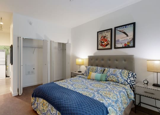 a bedroom with a bed and two night stands with lamps