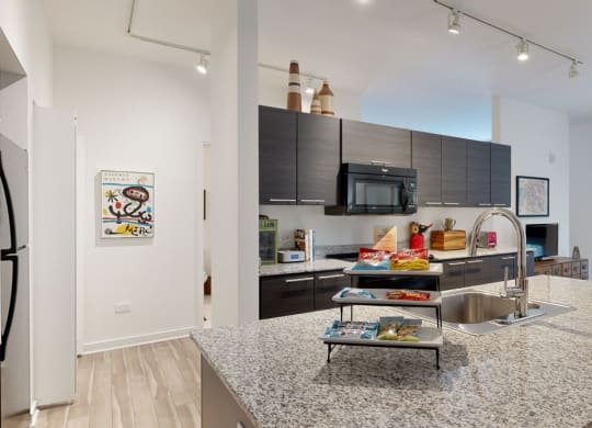 a kitchen with a large island and stainless steel appliances