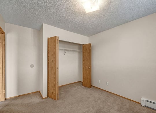 a bedroom with a closet and a door to a closet