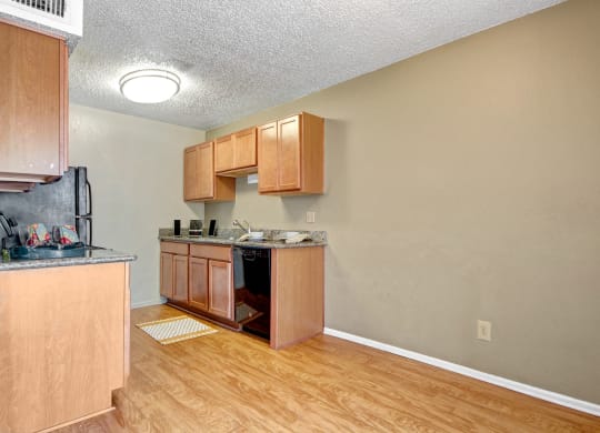 an empty kitchen with wooden cabinets and a counter top